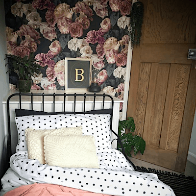 small bedroom with dark floral wallpaper