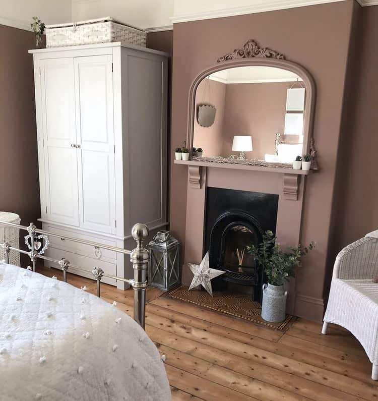 traditional bedroom with sulking room pink paint from farrow & ball, white furniture and wooden flooring