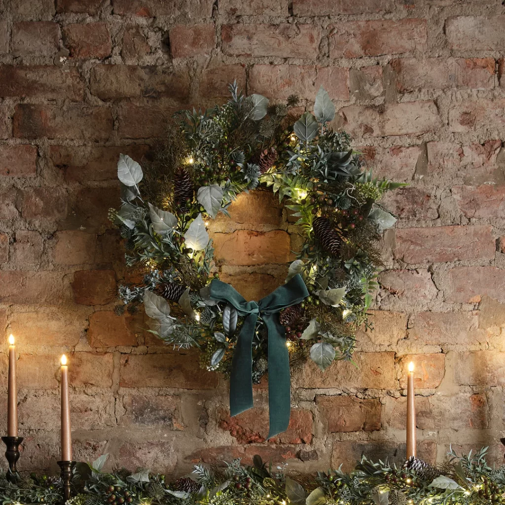Green foliage pre-lit wreath with velvet bow