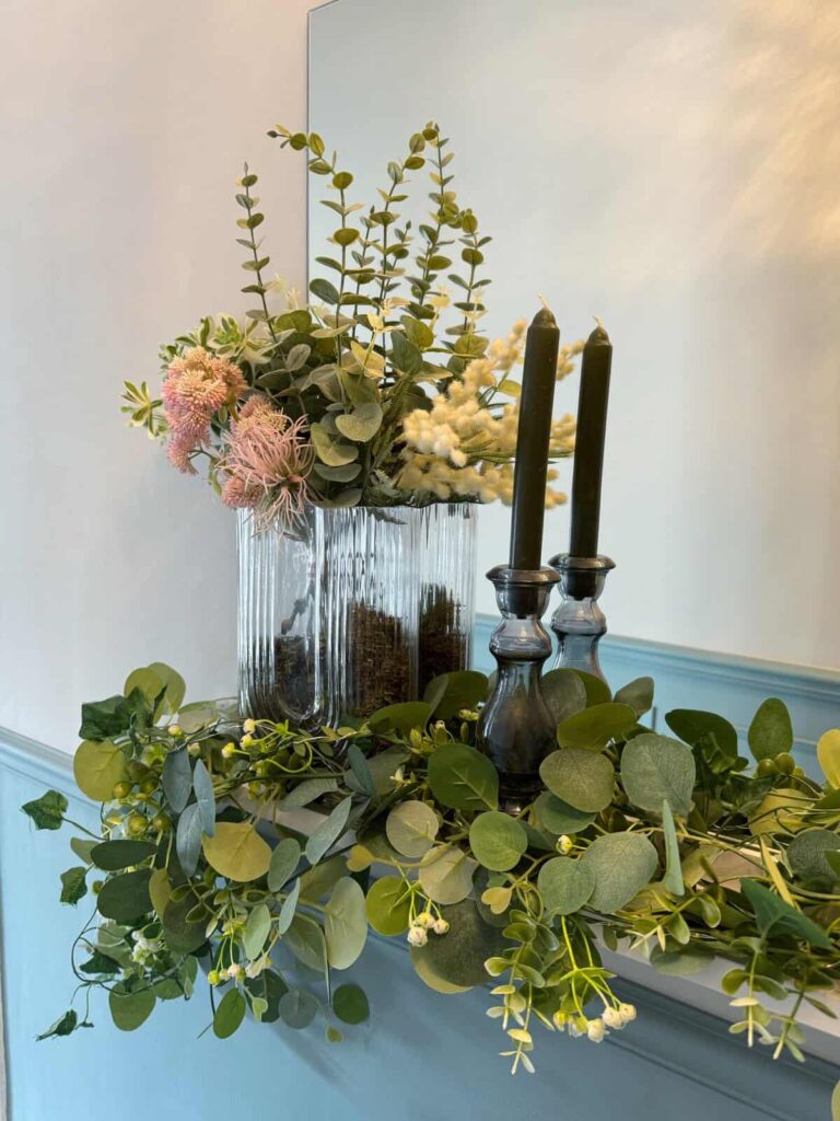 Faux floral display on shelf in Hallway. Candles and Fairylights. After Renovation.