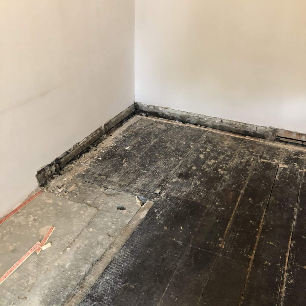 Old Victorian flat flooring and skirting boards taken off. Mid Renovation.