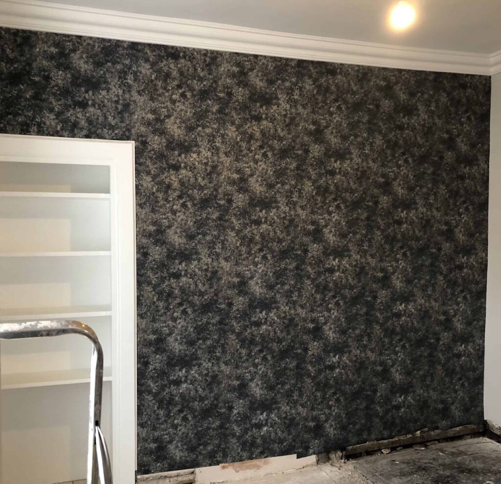 Navy blue textured wallpaper completed - mid renovation.