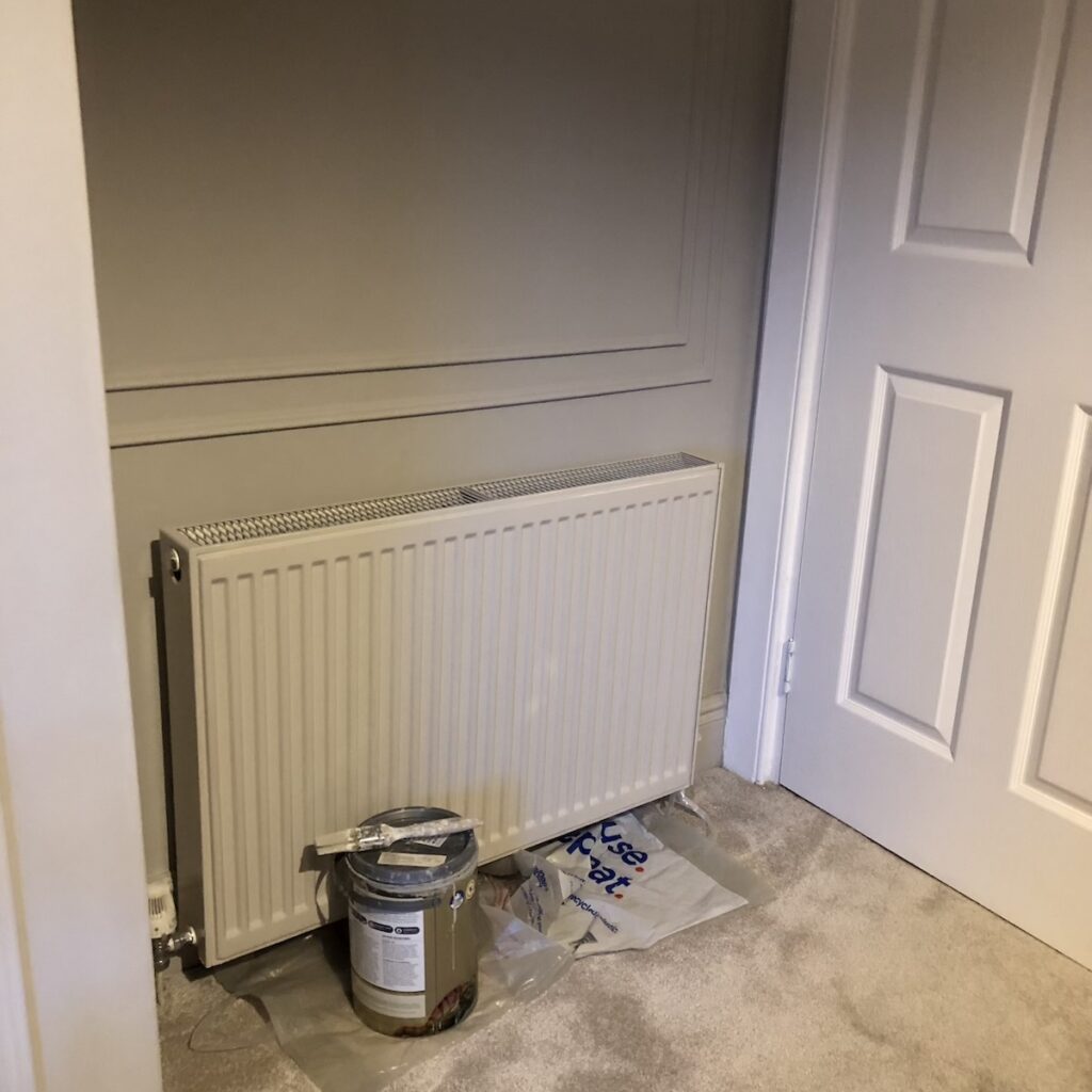 Radiator painted the same colour as the walls - Purbeck Stone by Farrow & Ball