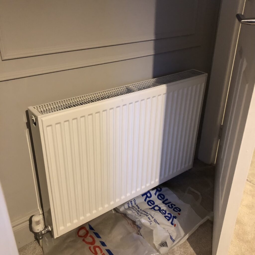 White radiator before being painted the same colour as the walls - Purbeck Stone by Farrow & Ball